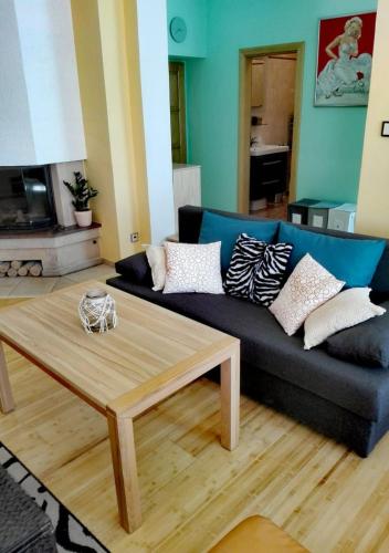 a living room with a blue couch and a coffee table at Apartment Villa Frank in Mariánské Lázně