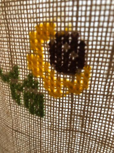 a group of yellow flowers on a white grate at Alojamiento LA DUQUESITA in Alba de Tormes