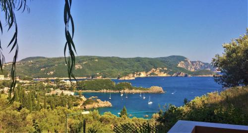 a view of a bay with boats in the water at Villa Amaryllis in Paleokastritsa