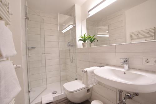 a bathroom with a sink and a toilet and a shower at Fischener Biberle in Fischen