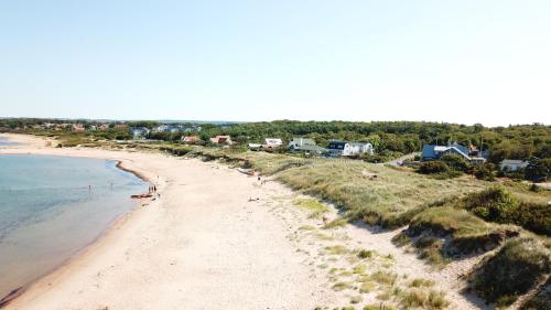 an aerial view of a beach with houses and the ocean at Vejby Strand Hotel in Vejbystrand
