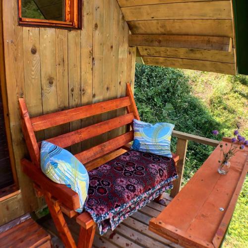 a bench sitting on the porch of a cabin at Kamp Vrbnica in Pluzine