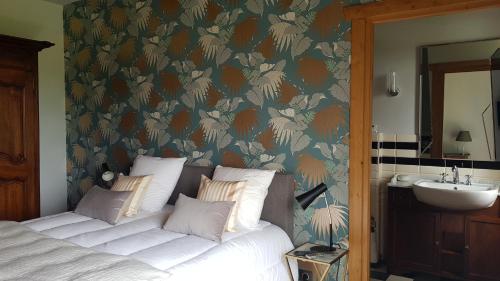 a bedroom with a bed and a bathroom with a sink at Maison d hotes Lapitxuri in Arcangues