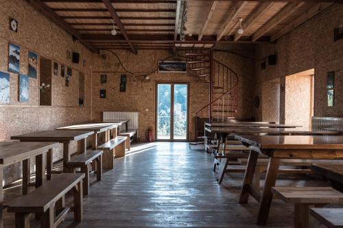 an empty room with wooden tables and benches at Katafugio Mpafi in Athens