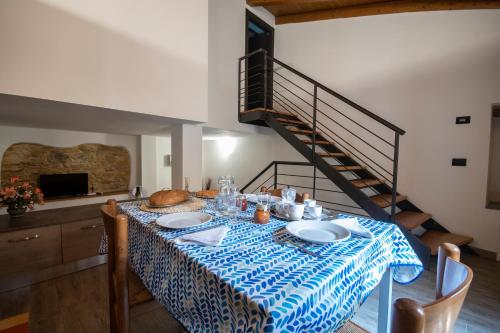 a dining room table with a blue and white table cloth at Agriturismo De Ferrari in Onzo