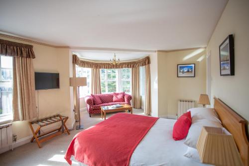 a bedroom with a large bed with a red blanket at Links Country Park Hotel in Cromer