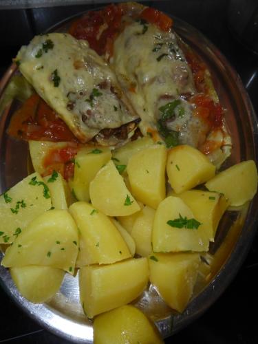 a bowl of food with meat and potatoes on a table at Schwaighof in Oberau