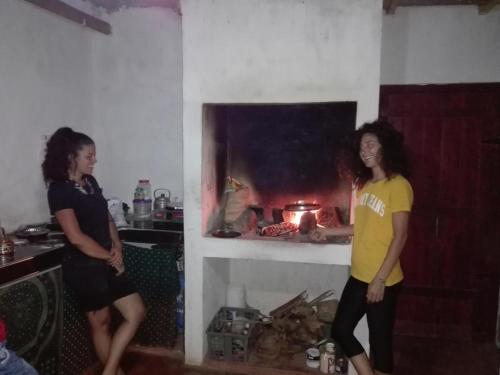 two women standing in a room with a fireplace at Light house beach home in Matara