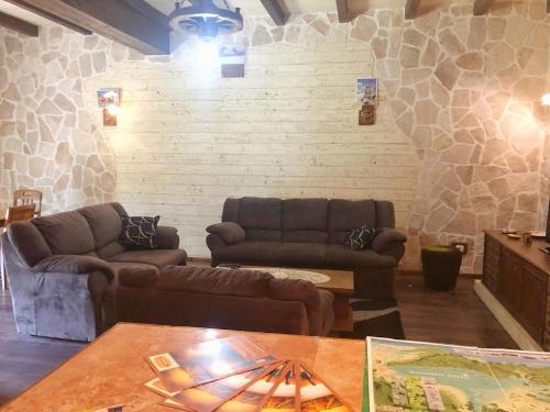 a living room with two couches and a table at Holiday Home Ivana in Virpazar