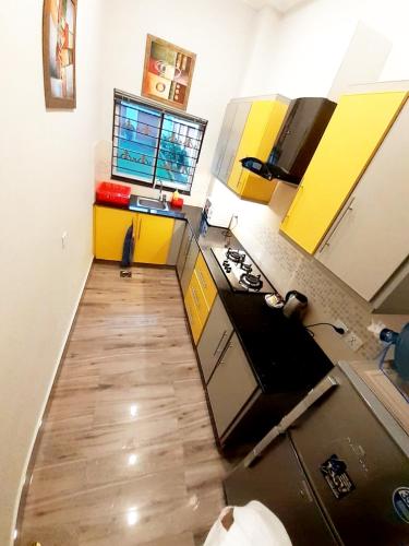 an overhead view of a kitchen with yellow cabinets at Hayyat Luxury Hotel Apartments in Lahore