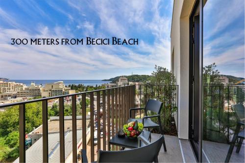 a balcony with a chair and a bowl of fruit at Hotel Kalos in Budva