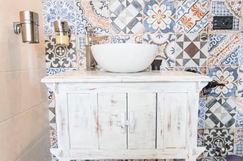 a bathroom with a white bowl on top of a cabinet at Relais Garibaldi in Avezzano