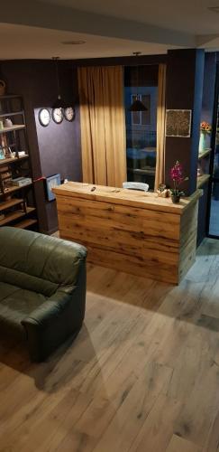 a living room with a couch and a reception desk at Hilltop Kazbegi in Stepantsminda