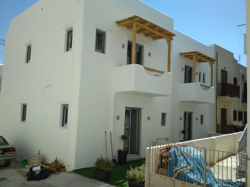 a white building with stairs on the side of it at Majestique of Naxos luxury suites in Naxos Chora