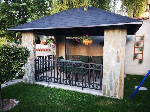 a gazebo with a table and chairs at Villa i SPA Stević in Veliko Gradište