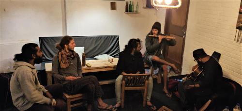 a group of people sitting in a room at La Voglia-Old Manali in Manāli