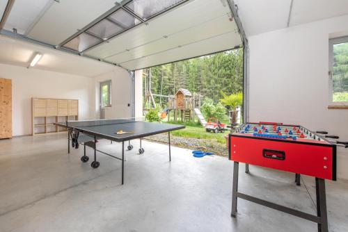 a ping pong room with a ping pong table at Apartmenthaus Fuchsmaurer in Bressanone