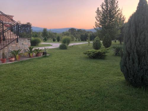 a view of a yard with trees and a road at Villa Katerina & Pool in Gevgelija