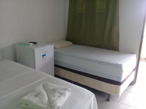 Säng eller sängar i ett rum på Pousada Beira Rio