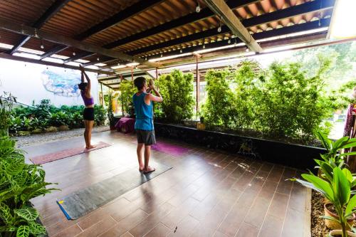 two men doing yoga in a room with plants at Bodhi El Valle in Valle de Anton