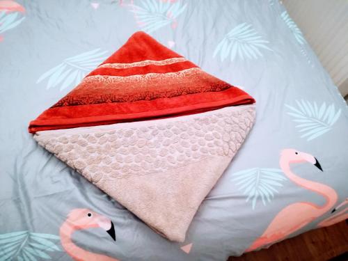 a towel on a bed with two pink flamingos at excellent location in Wrocław