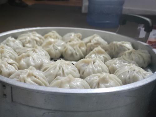 a pan filled with dumplings in at Sehrish Guest House Skardu in Skardu