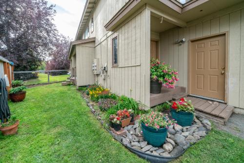 a garden with flowers in pots on the side of a house at Polar Bear Den in Anchorage
