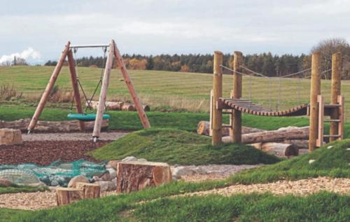 a playground with a swing set and a slide at Olavat Cottage detached property with parking in Inverness