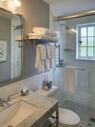 a bathroom with a toilet and a sink and a shower at Granville Inn in Granville
