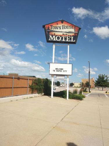 a sign for a town house motel on a street at Town House Motel in Rapid City