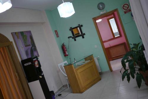a room with a room with a door and a room with aperature at Hostal El Alba in Brunete