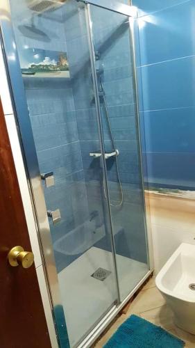 a glass shower in a bathroom with a toilet at En Marina D'Or primera linea real in Oropesa del Mar