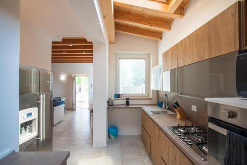 a kitchen with a stove top oven next to a window at Gate To Verona in Verona