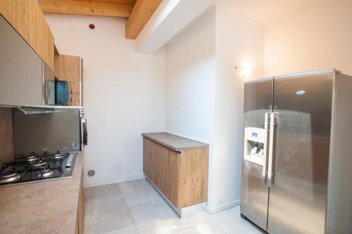 a kitchen with a stainless steel refrigerator and a stove at Gate To Verona in Verona