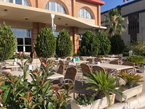 a restaurant with tables and chairs in front of a building at Los Bronces in Lucena