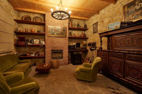 a living room with a couch and a fireplace at Ethno Sazano Hotel in Sazano