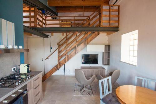 a kitchen with a wooden staircase and a table at Gate To Verona in Verona