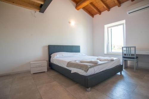 a bedroom with a bed and a chair and a window at Gate To Verona in Verona