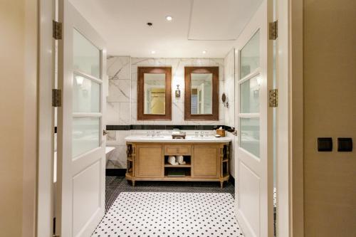 a bathroom with a sink and a mirror at Feliz Hotel Boracay in Boracay