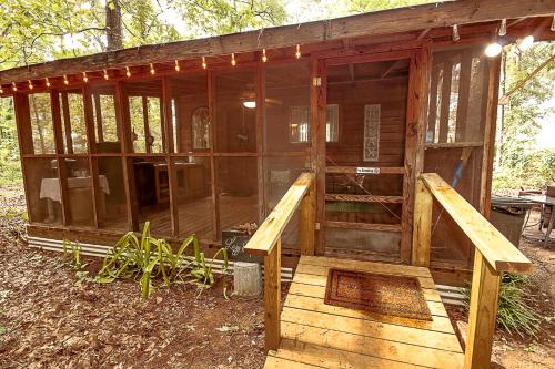 a wooden house with a wooden ramp in the woods at The Lazy Squirrel in Tyler