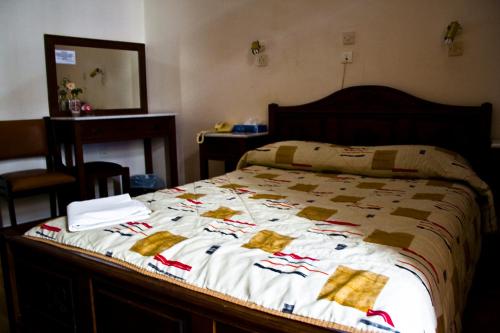 a bed with a christmas quilt on it at Acropolis House in Athens