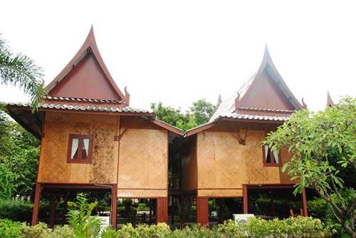 a large building with two peaked roofs at บ้านไทยรีสอร์ท in Ban Wang Kran