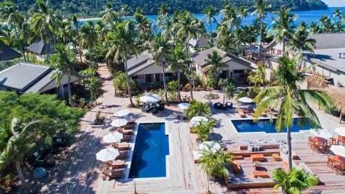 an aerial view of a resort with a pool and palm trees at Paradise Cove Resort in Naukacuvu Island
