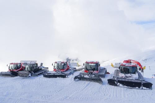 a group of snow tractors on a snow covered slope at Casa Campanula in Laax
