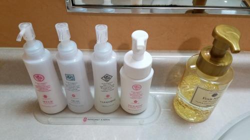 four bottles of moisturizers sitting on a tray in a sink at Hotel GOLF Hodogaya (Adult Only) in Yokohama