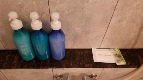 three bottles of water on a counter in a bathroom at Hotel GOLF Hodogaya (Adult Only) in Yokohama