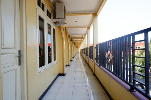 an empty hallway of a building with a balcony at RedDoorz Plus near Stadion Wijaya Kusuma in Cilacap