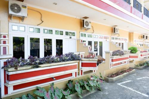 a building with flowers on the side of it at RedDoorz Plus near Stadion Wijaya Kusuma in Cilacap