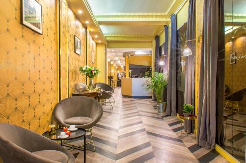 a corridor with chairs and tables in a room at Best Western Hotel Centre Reims in Reims