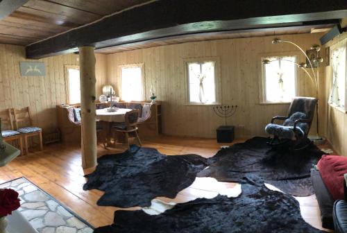 a living room with a large rug on the floor at Chalet anno 1794 in Rettenegg